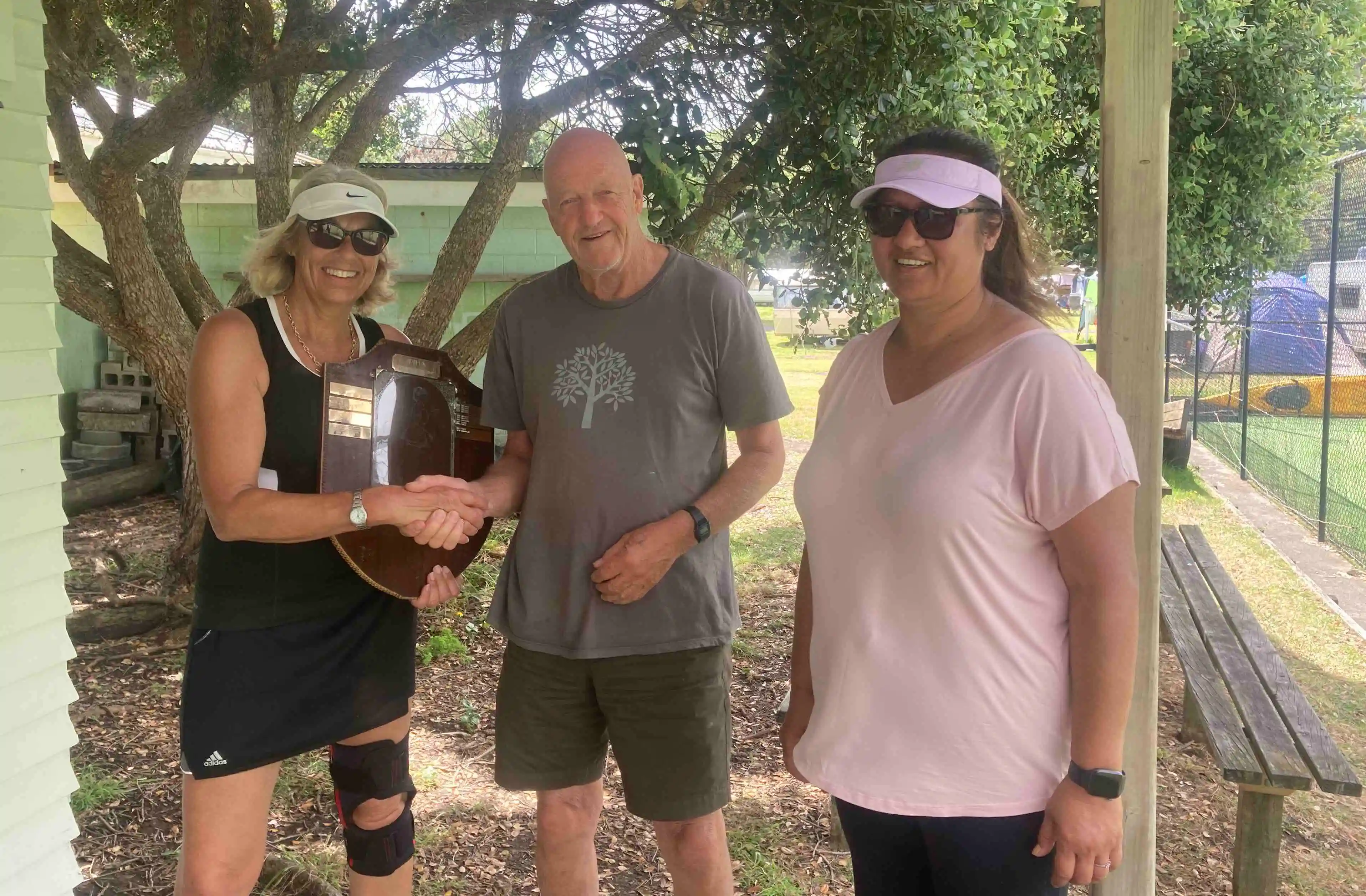 Women's Singles finalists 2021: Gayle Barclay is presented with the Bill Rollo Shield by President Peter Hosking. Runner up Toni Vaughan on right.